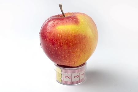 Apple and tape line on white background.