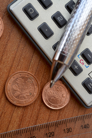 money, calculator, table and pen.