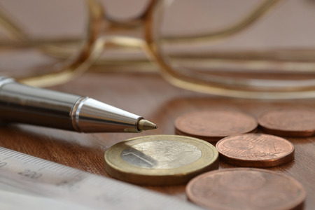 Financial background with money, ruler, glasses and pen.