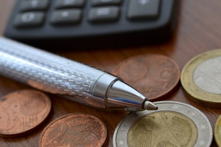 Financial background with money, calculator, table and pen.
