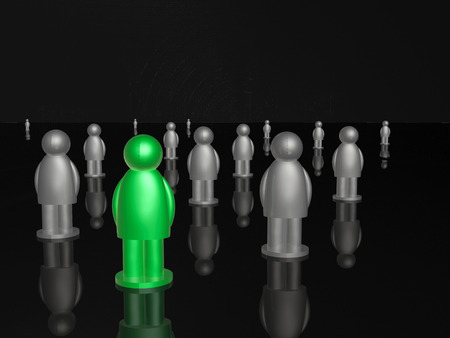 Green and grey mans on black reflective background.の写真素材
