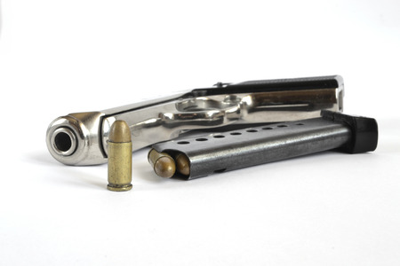 Pistol and ammunition on the white background.