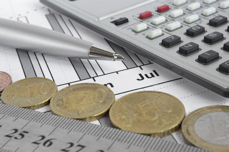 Financial background with money, calculator, ruler, graph and pen.の写真素材