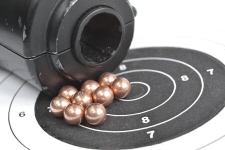 Airgun and bullets on the target background.