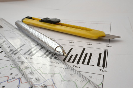 Business background with graph, ruler, pen and cutter.の写真素材