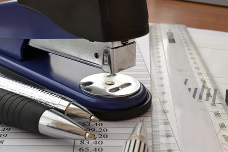Business background with table, ruler and puncher.