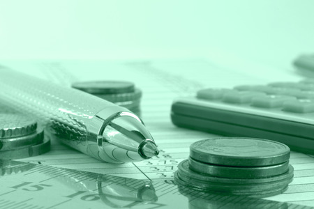 Financial background with money, calculator, ruler, graph and pen.の写真素材