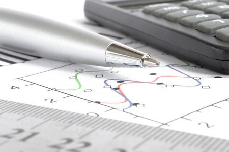 Business background with graph, ruler, pen and calculator.
