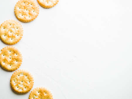 Crispy round crackers on white background. Dry crunchy cookies. Studio shot.の写真素材