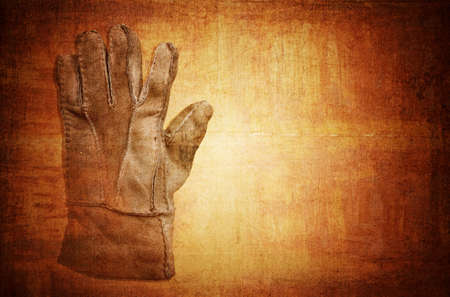 old glove on grungy backgroundの写真素材