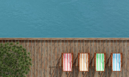 Top view of four deckchairs on a wooden pier - renderingの写真素材