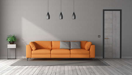 Modern living room with orange sofa in a gray room with closed doorの写真素材