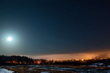 Moon with clouds in the night sky. Cold winter in Lithuaniaの写真素材