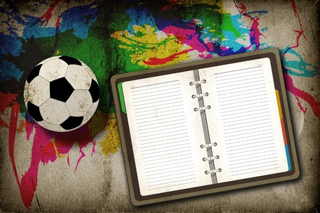 Football and blank notebook on vintage backgroundの写真素材