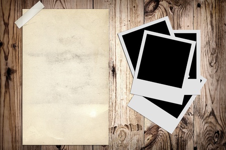 Blank photo and old poster on wooden backgroundの写真素材