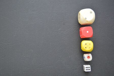 Game dice in the composition of different cubes on backgroundの写真素材