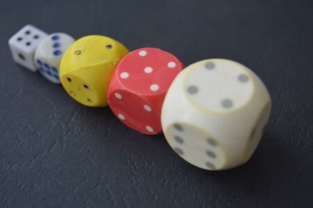 Game dice in the composition of different cubes on background
