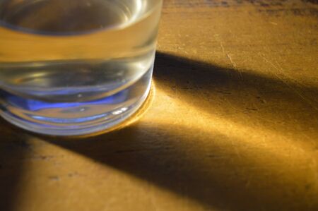 Lighting effects of a glass product on a brown the tableの写真素材