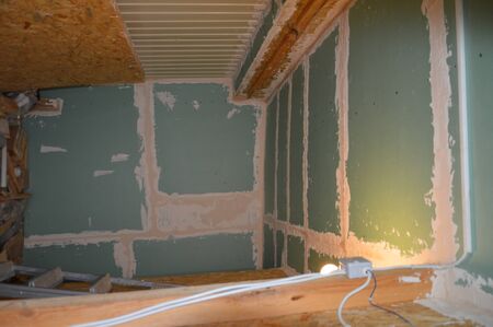 Puttying walls and cracks with a solution of finishing puttyの写真素材