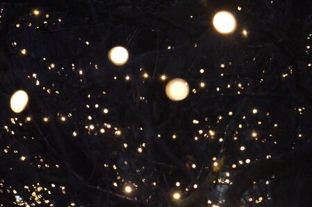 New Year's blurry garlands glow at night in composition