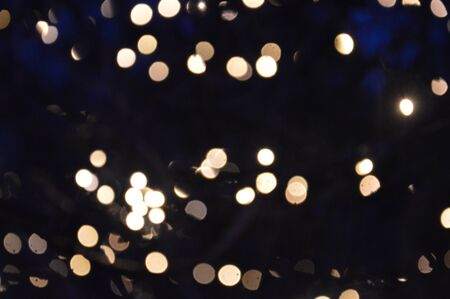 New Year's blurry garlands glow at night in composition