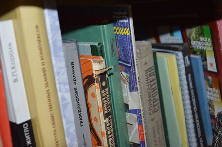 KIEV, UKRAINE - JANUARY 5, 2020: Different books on a shelf the standのeditorial素材