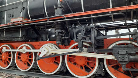 An old steam locomotive stands at the in station in detail