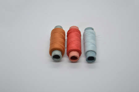 Threads and spools for sewing clothes on a white the background