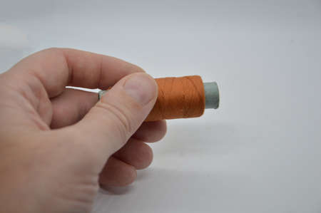 Threads and spools for sewing clothes on a white the background