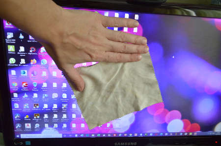 KIEV, UKRAINE - FEBRUARY 2, 2021: Microfiber cleaning with spray liquid the crystal panels