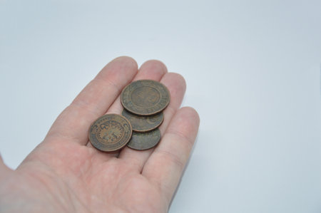 Metal coins of the Bank of Tsarist Russia in the hand of a the manの写真素材