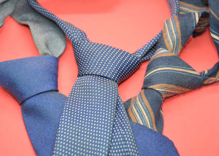 Composition with knotted men's ties with cushions on a the background