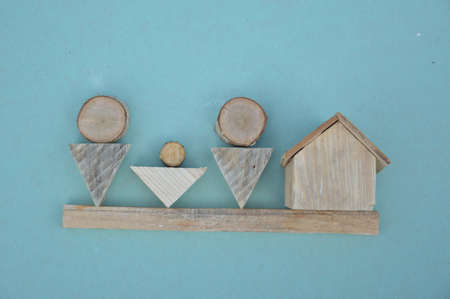 Wooden model of a house and the family
