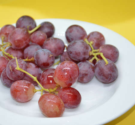 Large red grapes on a the plateの写真素材