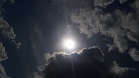 Glowing sun between the clouds