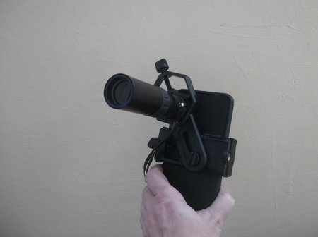 Attachment between monocular telescope and smartphone on a tripodの写真素材