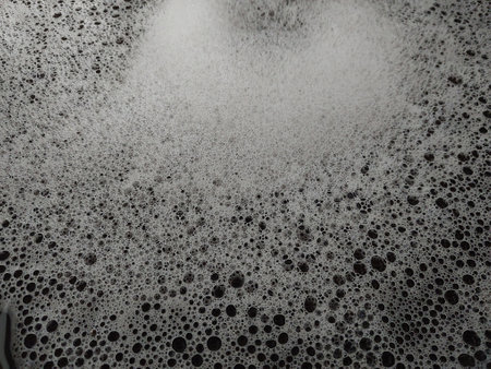 Texture of dishwashing detergent foam in the sinkの写真素材
