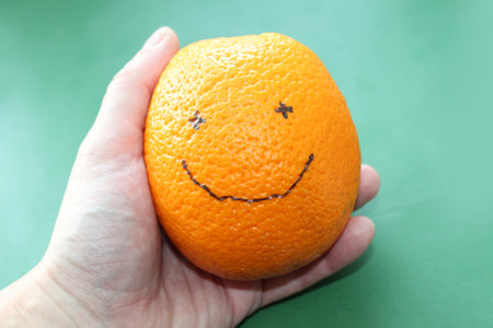 Smiling orange on a green background