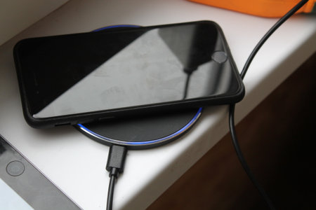 KYIV, UKRAINE - February 21, 2024: Charging an Apple smartphone, wired or the wireless