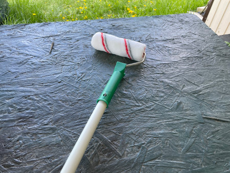 A paint roller placed on a table, ready for use.の写真素材