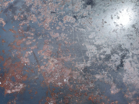 A close-up image showing a protective solvent-based coating being applied to a metal surface to prevent rust and corrosion.の写真素材