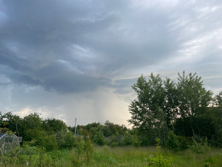 A dramatic sky with dark, heavy clouds signaling an approaching rainstorm.の写真素材