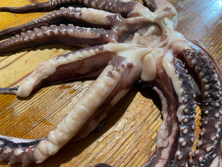 Fresh octopus being prepared and cooked in a home kitchen.の写真素材