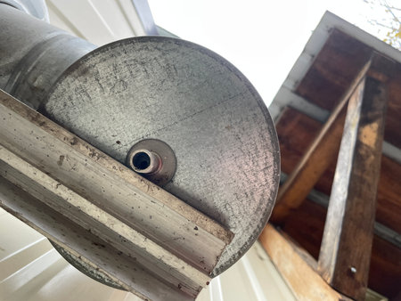 Chimney mounting brackets installed on the wall of a wooden frame house