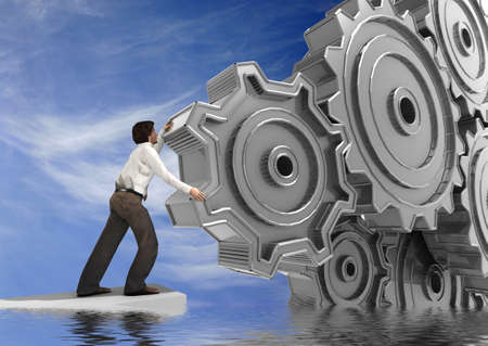 Businessman Turning a Gear の写真素材