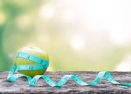 Slim diet, eating habit for healthy living and anti-aging concept with measuring tape wrapping...