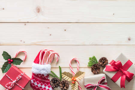 Christmas gift background with red box of present on white pine wood background for X'mas winter holiday backdrop and design decorationの写真素材