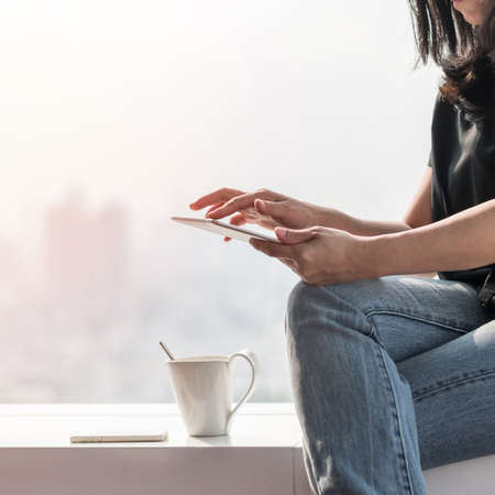 Digital lifestyle blog writer or business person using smart device working on internet communication technologyの写真素材