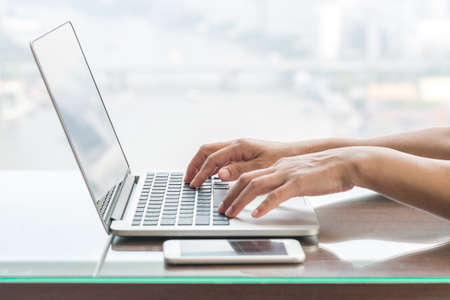 Digital lifestyle blog writer or business person using smart device working on internet communication technologyの写真素材
