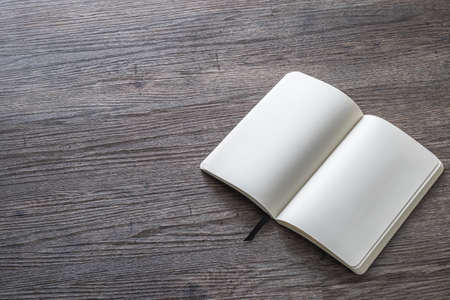Blank book mock up, catalog, magazines, brochure, or note cover template, white paper texture on wood tableの写真素材